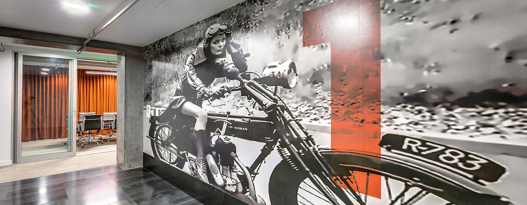 motorcycle photo mural on corridor wall