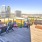 Large rooftop patio with fire pits and seating 
