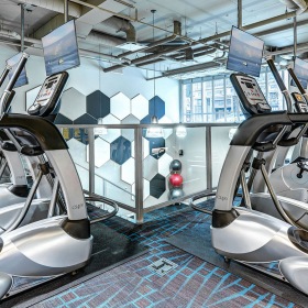 Fitness Center Large fitness center with cardio and weight lifting equipment.