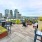 tables and chairs on rooftop terrace with city views